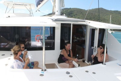 Whitsunday Escape Leopard 44 sailing catamaran cockpit fwd sunset drinks cheers relax girls trip
