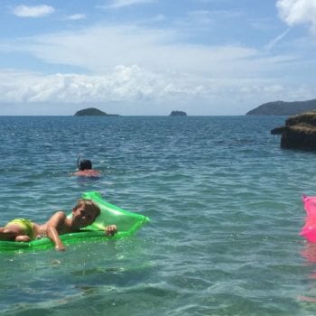 Floating around on lilos at Caves Cove in the sun - bareboating Whitsundays