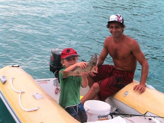 Kids catching fish when they go bareboating in the Whitsundayys