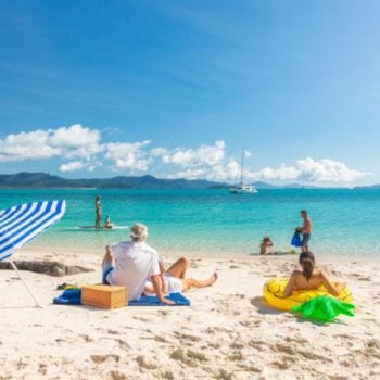 Family spending time together on a beach in the Whitsundays