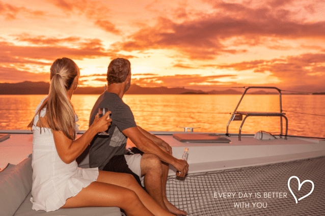 Sunset bareboating couple romantic love getaway in the Whitsundays